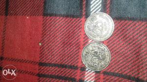Two Round Silver-colored 25 Paise Coins