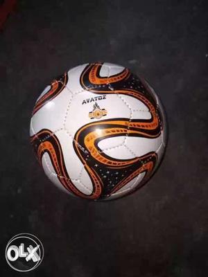 White, Black, And Orange Soccer Ball