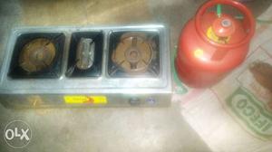 Gray Gas Stove With Red small Propane Tank