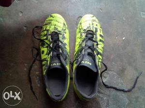 Pair Of Green-and-black soccer shoes (encounter)