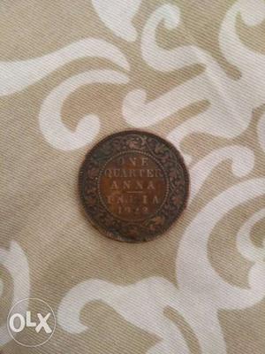 Round Copper-colored 1 Quarter Anna Indian Coin