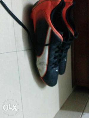Pair Of Black-and-orange Puma football Shoes