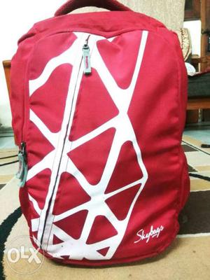 Red and white coloured skybag.A very spacious and