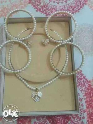 White Beaded Necklace And Four Bracelets