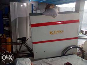 Battery rickshaw with White And Red King iron Board as a