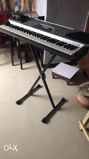 Black And Gray Electronic Keyboard With Black Stand