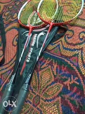 Two Red-and-black Badminton Rackets With Bag