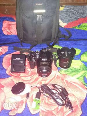 Black Nikon DSLR Camera With Camera Lens And Bag