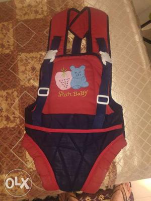Baby carrier in red and navy blue color, hardly