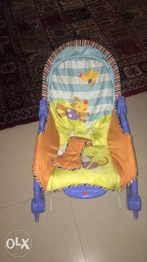 Baby's Green, Orange, And Blue Bouncer Seat