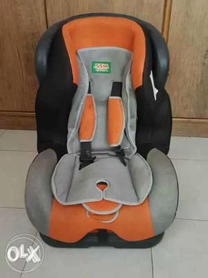Gray, Black, And Orange Booster Seat