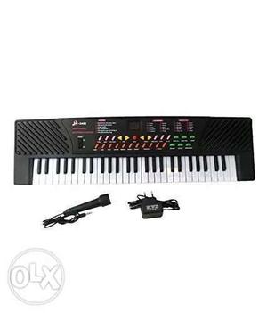 Black And White Electronic Keyboard With Charger