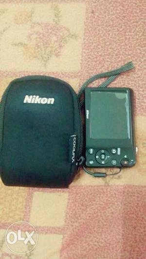 Black Nikon Point-and-shoot Camera With Case