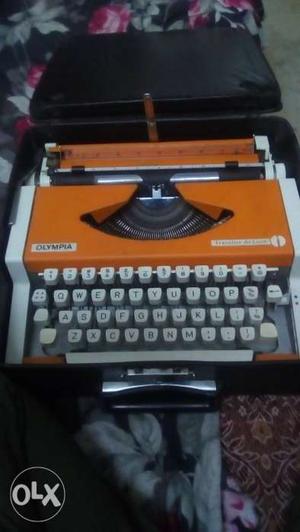 Orange And White Olympia Typewriter With Black Case
