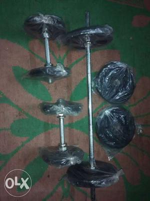 Two Black-and-silver rubber dumbell Dumbbells And Barbell