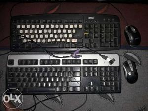 Two Pairs Of Corded Computer Keyboard And Mice