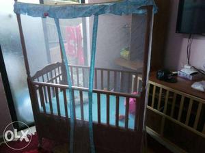 Brown Wooden Crib With Mosquito Net