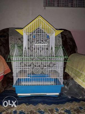 White, Blue, Green, And Yellow Metal Bird Cage