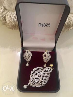 Brand new diamond encrusted pendant and drop earrings with