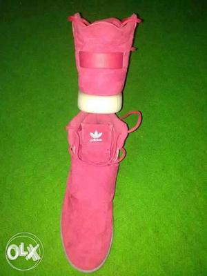 Pair Of Red Adidas Tubular Strap Sneakers