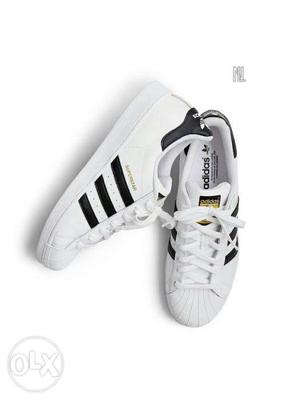 Pair Of White Adidas Superstar Sneakers