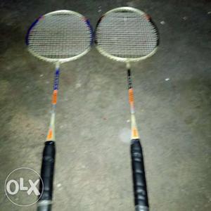Two Black-orange-and-white Badminton Rackets