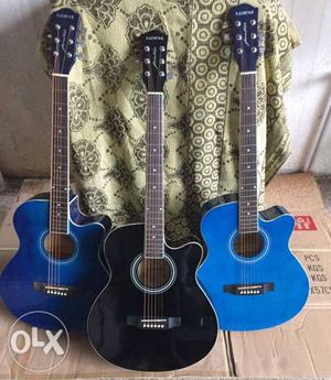 Two Cut-away Blue And One Black Acoustic Guitars