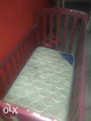 A baby bed with high quality mattress.