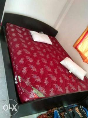 Black Wooden Bed Frame With Quatrefoil Red Floral Mattress