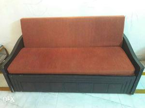 Brown Cushion Couch With Black Wooden Frame