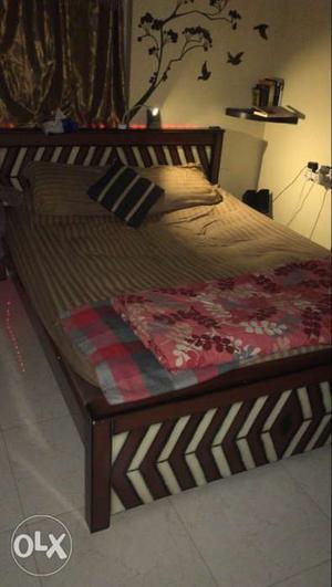 Brown Wooden Bed Frame And Brown Mattress