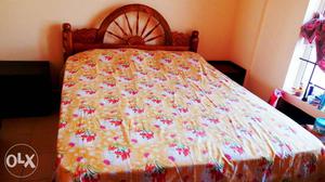 Brown Wooden Bed Framed And Yellow And Red Bedspread