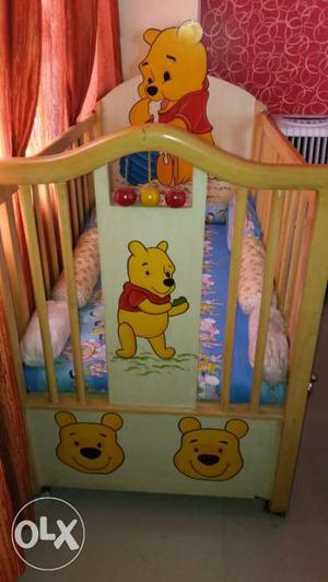 Brown Wooden Crib With Winnie The Pooh Prints