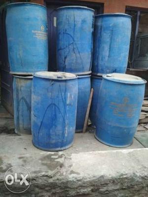 Eight Blue Plastic Barrels