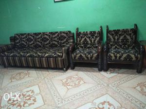 Two Black Wooden Framed Brown Padded Sofa