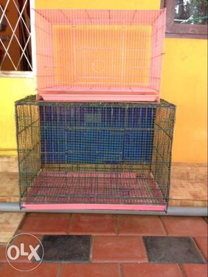 Two Pink And Black Metal Pet Cages