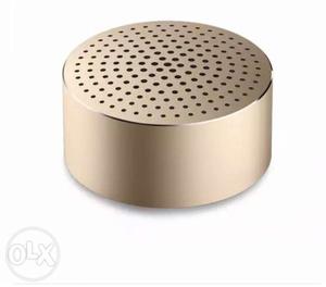 Cylindrical Gold-colored Portable Speaker