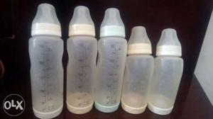 Five White Feeding Bottles