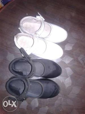 Two Pairs Of White And Black Velcro Shoes
