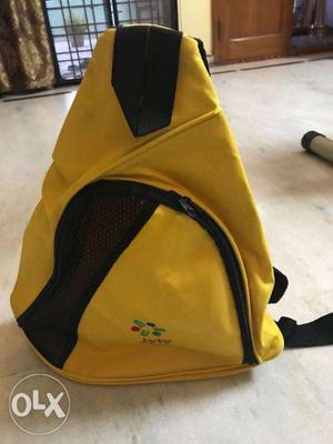 (used) yellow single strap backpack