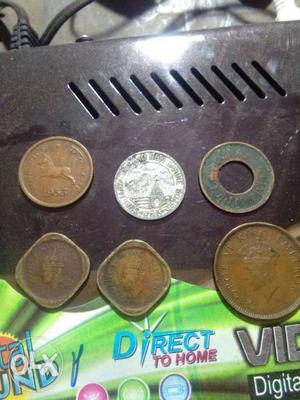 Five Copper-colored And One Silver-colored Coins