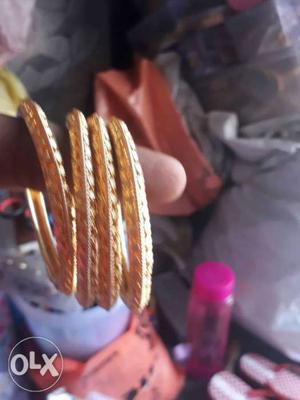 Four Gold-colored Cuff Bracelets