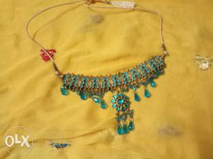 Gold-colored Blue Gemstone Encrusted Bib Necklace
