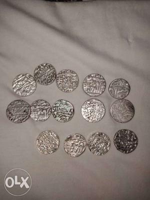 Round Silver-colored Mughal Coins