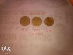 Three Round Gold-colored 50 Euro Cents