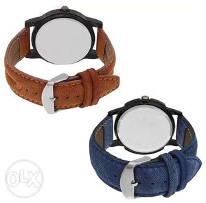 Two Round Black Watches With Brown And Blue Suede Straps