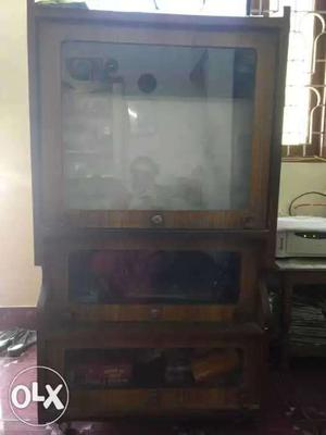 Black CRT TV With Brown Wooden TV Hutch