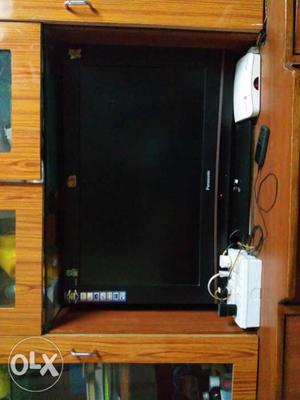 Black Flat Screen TV With Brown Wooden TV Stand