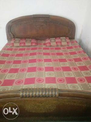 Brown Wooden Bed Frame And Pink And Brown Bed Sheet