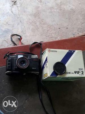 Black MF-2 Camera With White Box